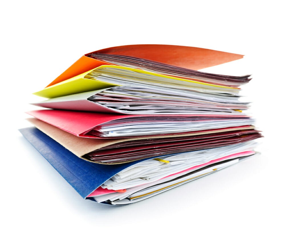Stack of colorful file folders with papers on white background